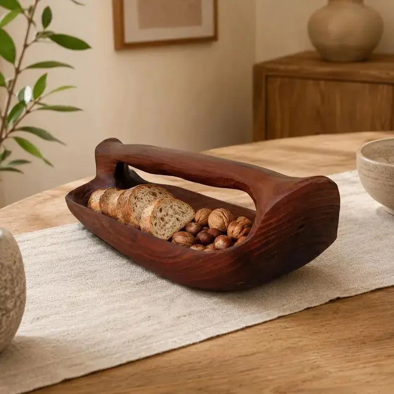 Russian olive wood bowl with a carved handle.