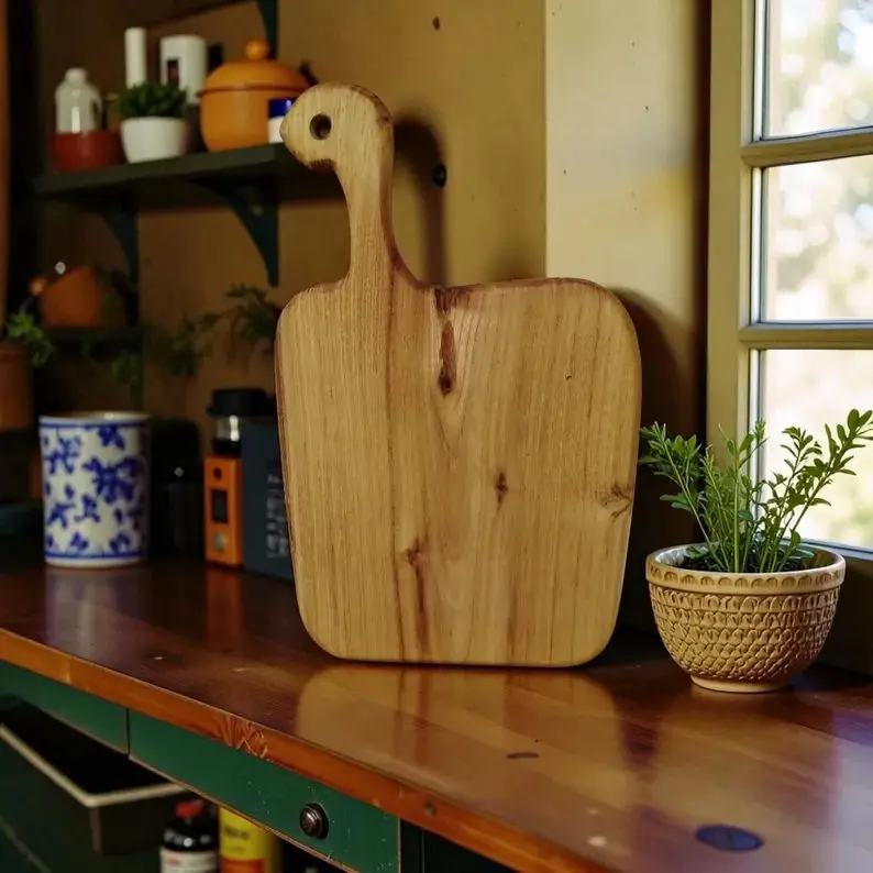 Handmade pear wood cutting board showing natural grain.