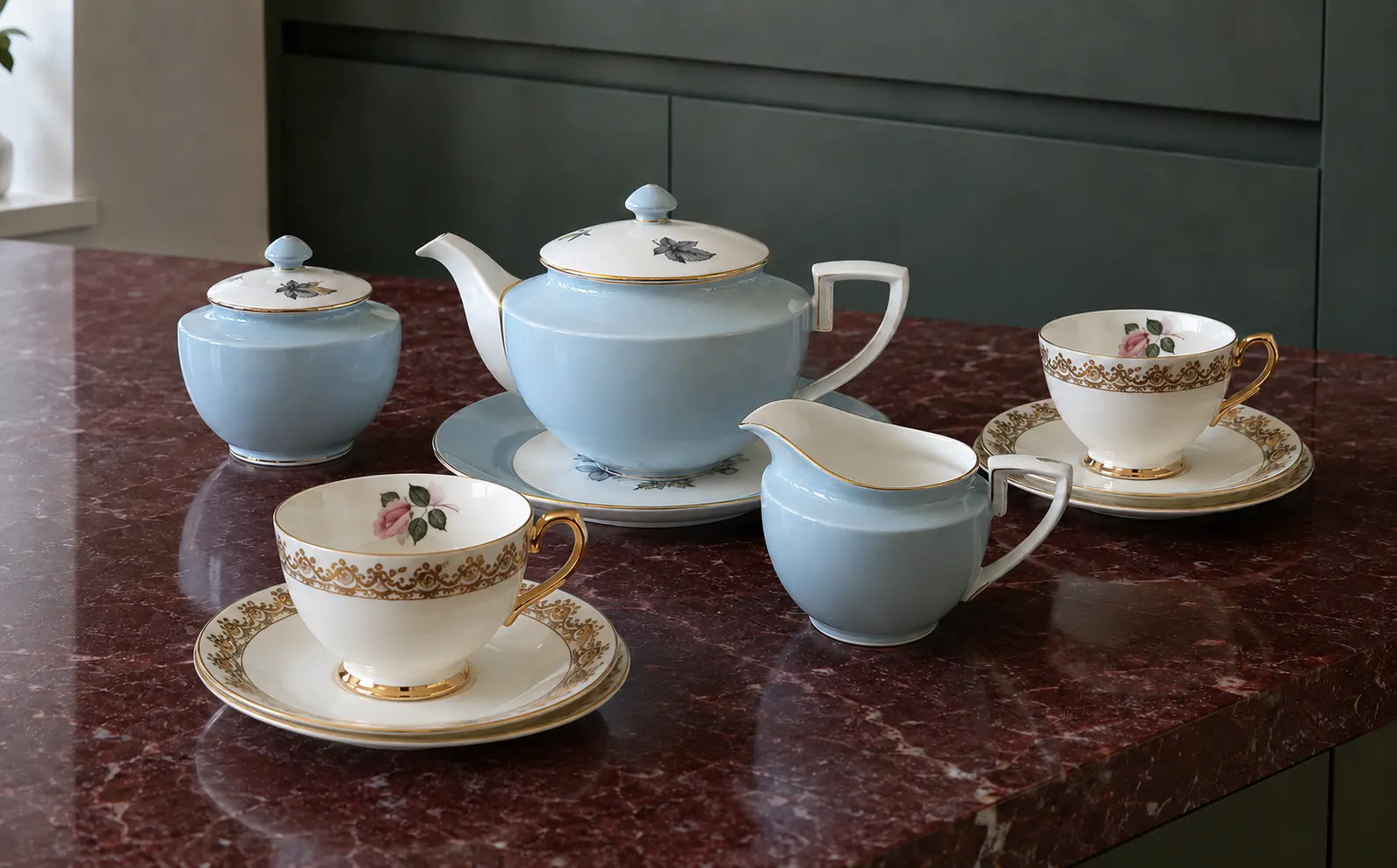 Vintage tea corner with a Royal Worcester Woodland tea set and two Taylor and Kent floral cups on a burgundy counter.
