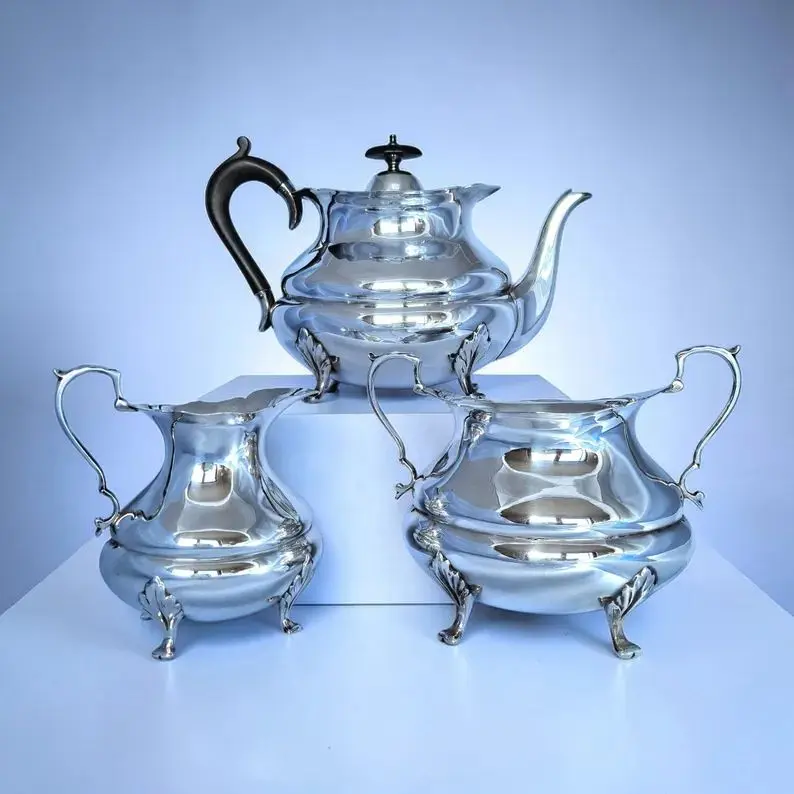 Complete antique Sheffield 1913 silver-plated tea set with teapot, sugar bowl and creamer.