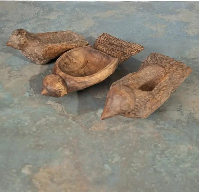 Handmade mulberry wood salt cellars with carved bird detail.