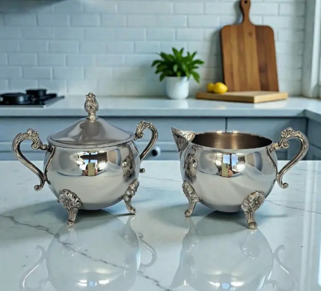 Antique silver-plated sugar bowl and milk jug set.