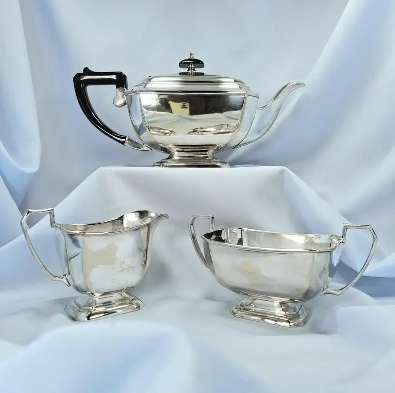 Vintage silver-plated teapot, sugar bowl and creamer set.