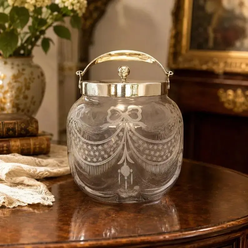 Antique etched glass biscuit barrel with a silver-tone lid.